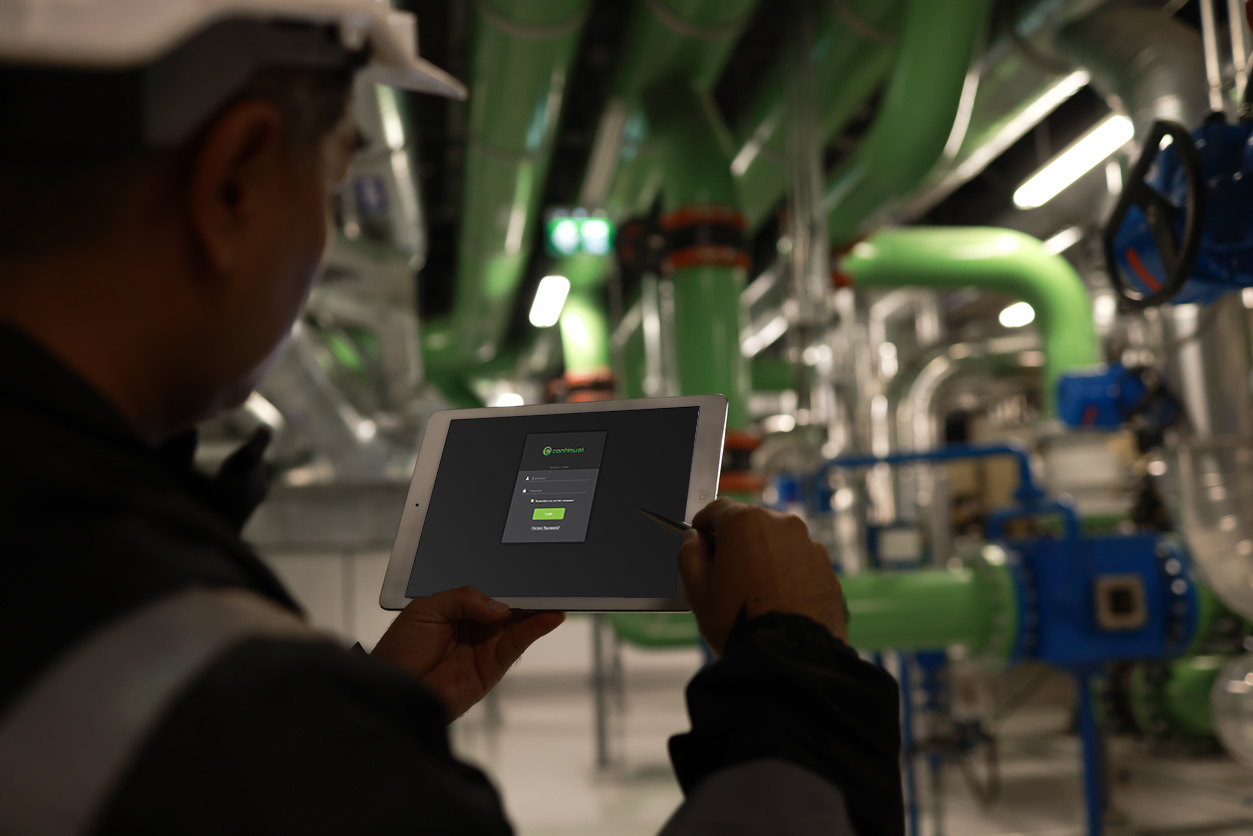 Person holding a tablet with Continual login page open